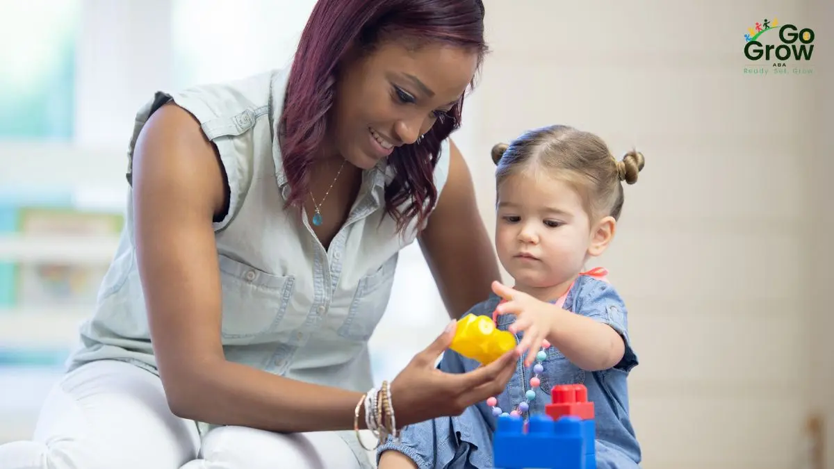 caregiver-supporting-toddler-during-block-play-and-fine-motor-learning