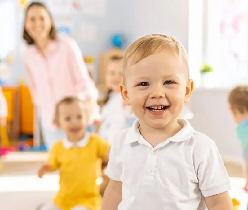 happy-young-child-playing-in-daycare-classroom-with-peers