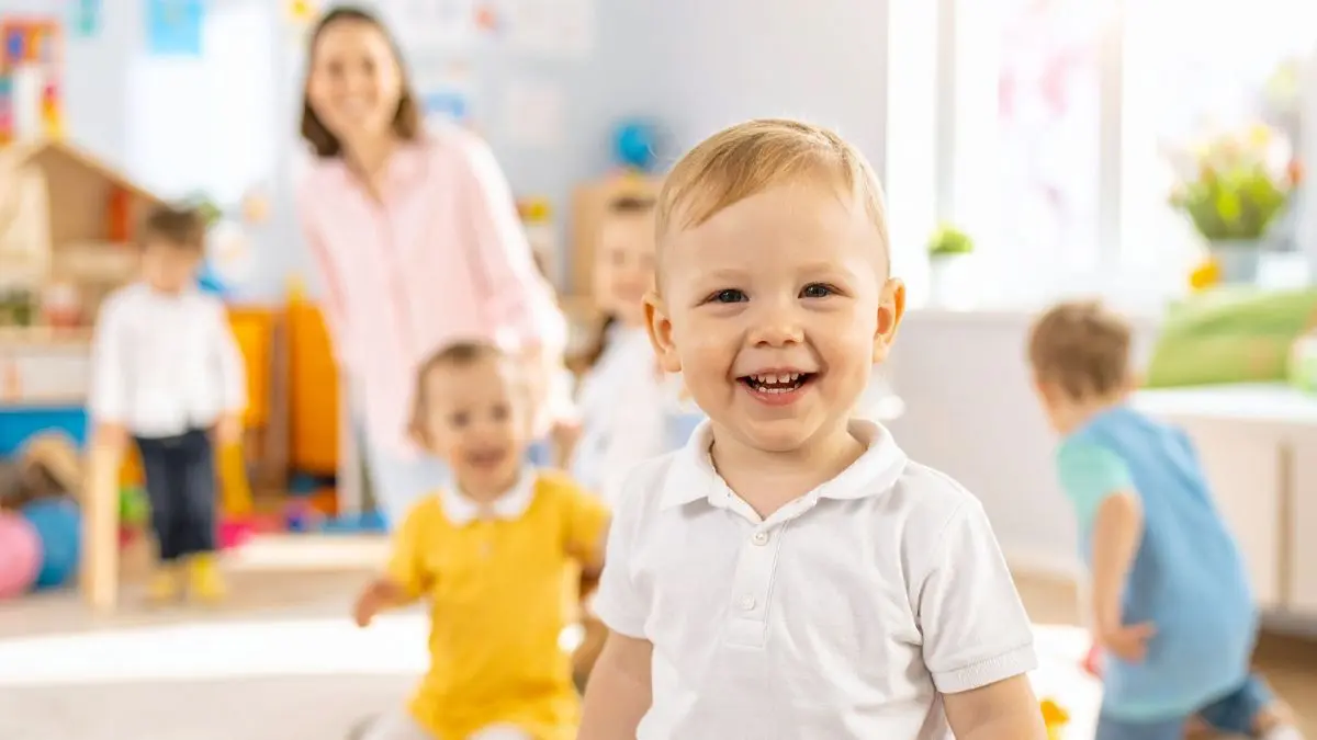 happy-young-child-playing-in-daycare-classroom-with-peers