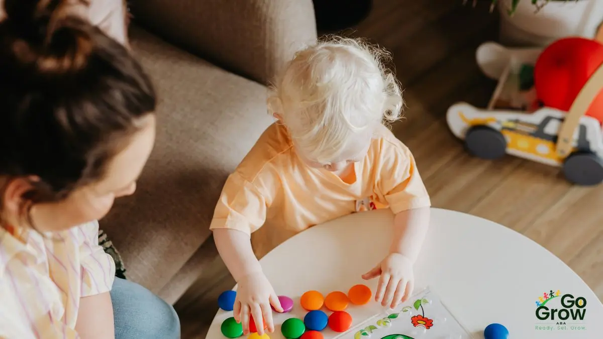 toddler-sorting-colorful-toys-at-table-during-play-based-learning