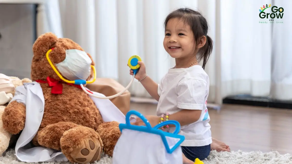child-playing-doctor-with-teddy-bear-at-home
