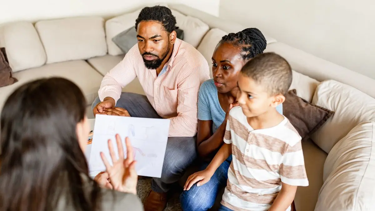 family-meeting-with-woman-showing-paper-in-living-room
