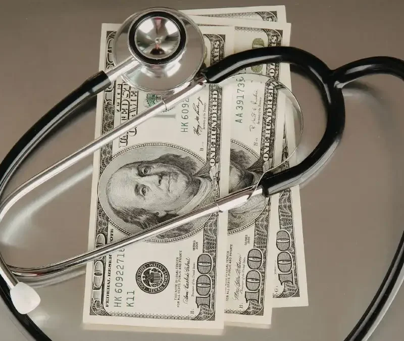 medical-stethoscope-with-cash-on-table