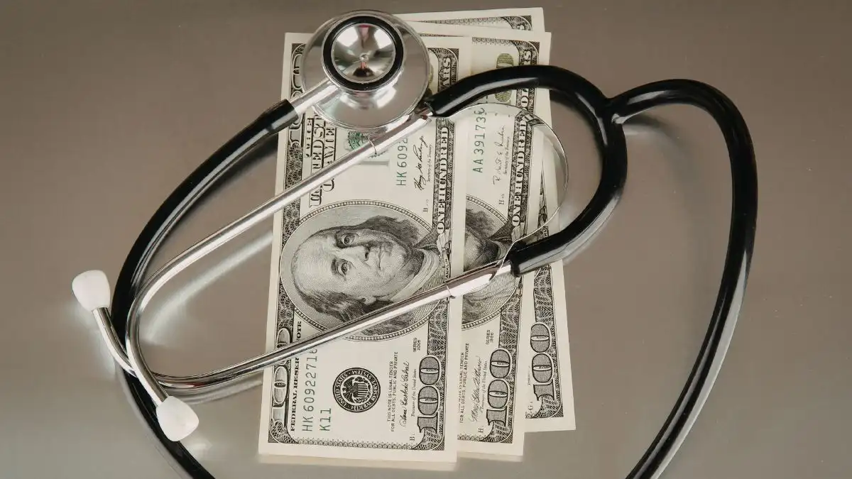 medical-stethoscope-with-cash-on-table