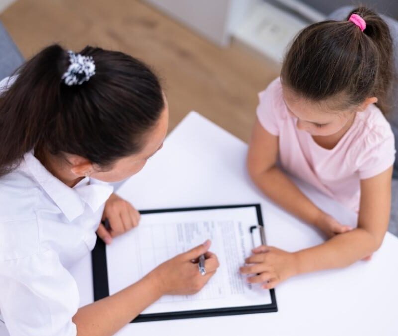 BCBA reviewing ABA therapy assessment with a child during first month of ABA therapy