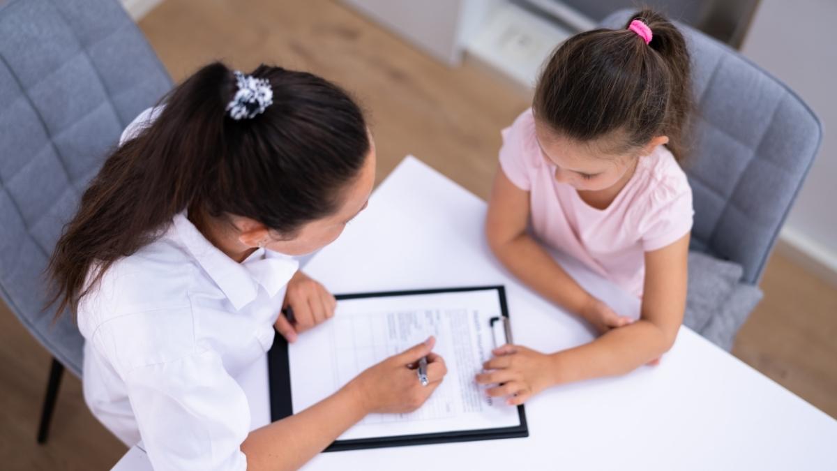 BCBA reviewing ABA therapy assessment with a child during first month of ABA therapy