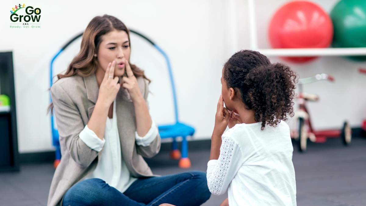 RBT modeling mouth movements to help a child practice communication skills during ABA therapy