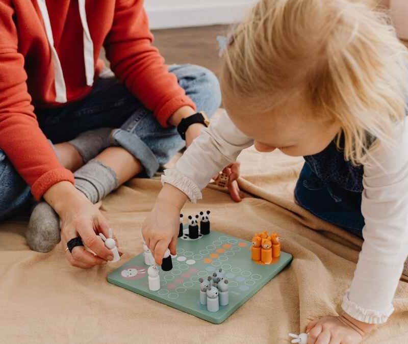 Therapist and child playing a board game during an in-home ABA therapy session in NJ