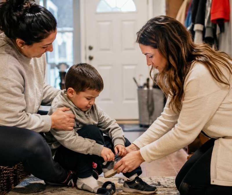 Two therapists helping a young boy with in-home ABA therapy in NJ