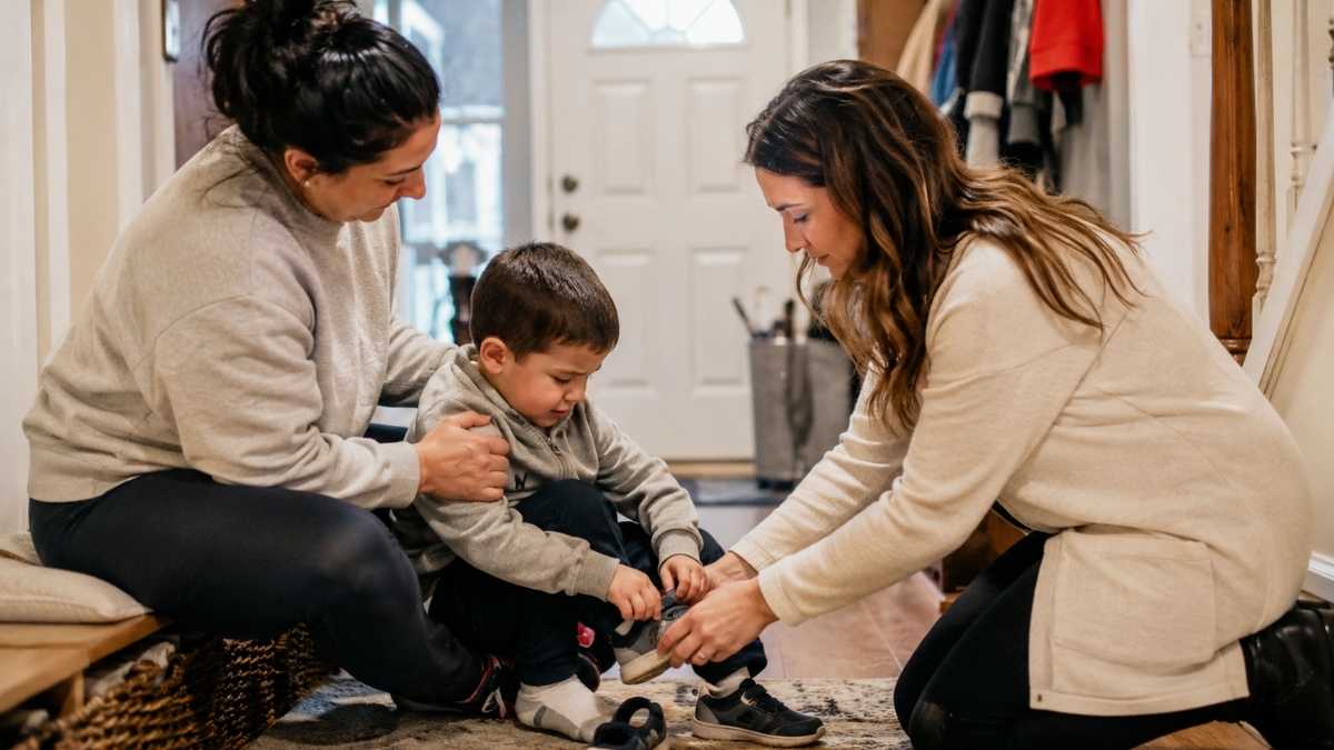 Two therapists helping a young boy with in-home ABA therapy in NJ